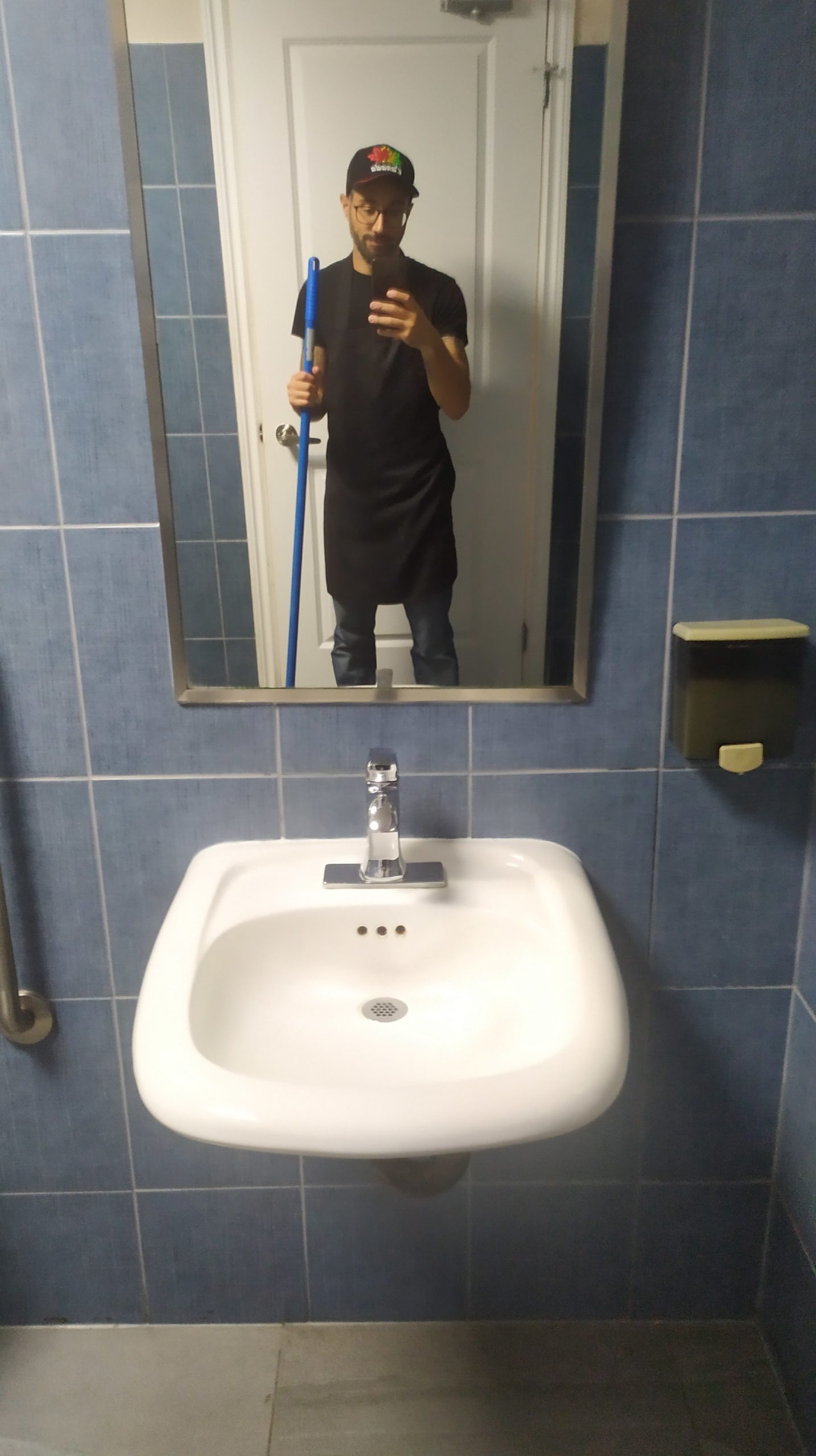 un selfie pris dans le miroir pendant que je nettoie le sol des toilettes pour homme